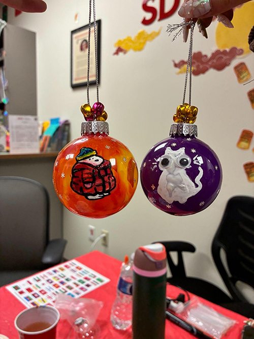 two jhand painted ornaments: Snoopy and white cat