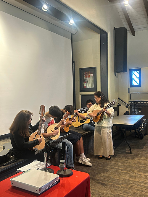 group of people playing a mandore