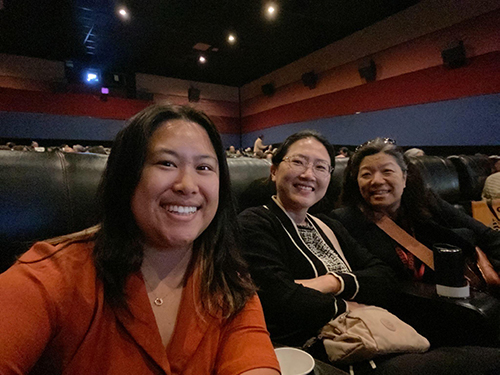 film festival audience, three people smiling
