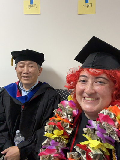student and faculty at commencement