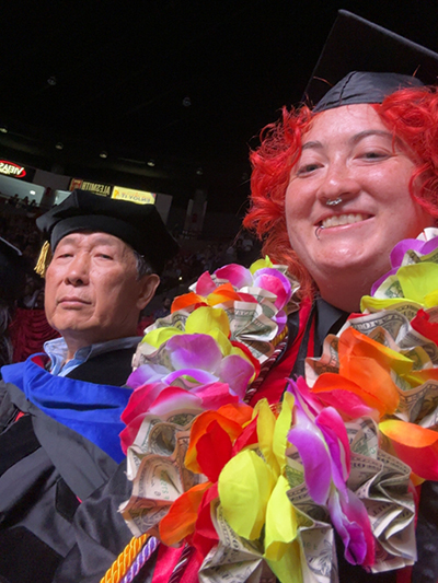 student and faculty at commencement