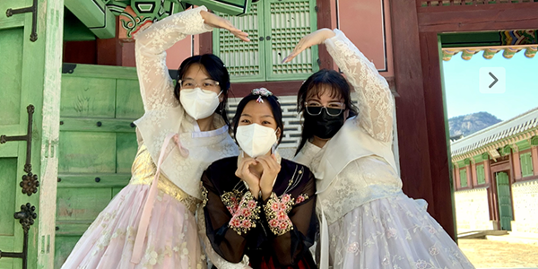 three students pose in Korea